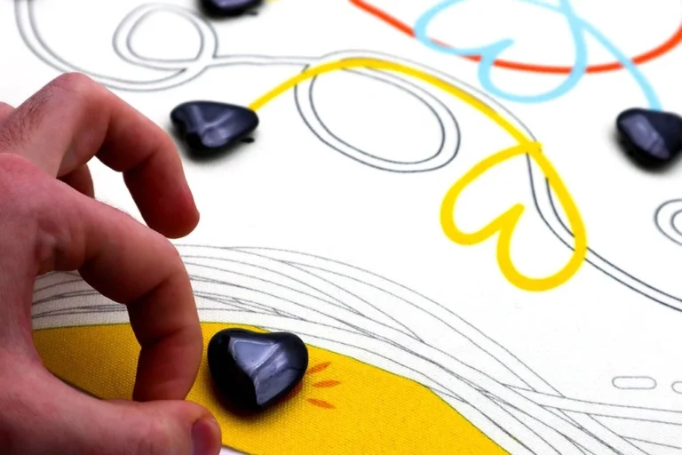 Main tenant pierre noire sur dessin coloré fleurs