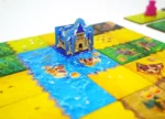 Jeu de société pop-up avec château bleu et plateau coloré